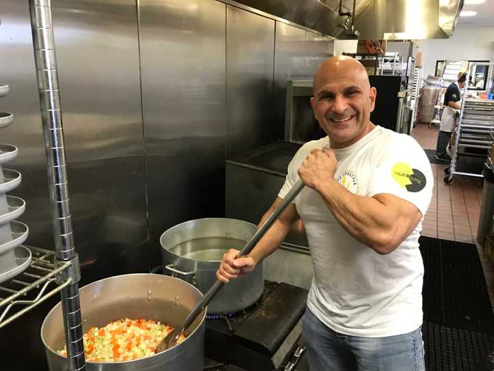 Carlo Filippone mixes vegetables at Elite Lifestyle Cuisine in Fairview.