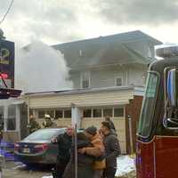 <p>Family members joined firefighters outside the Hawthorne home.</p>