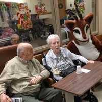 <p>Rudolph photo-bombs this couple.</p>