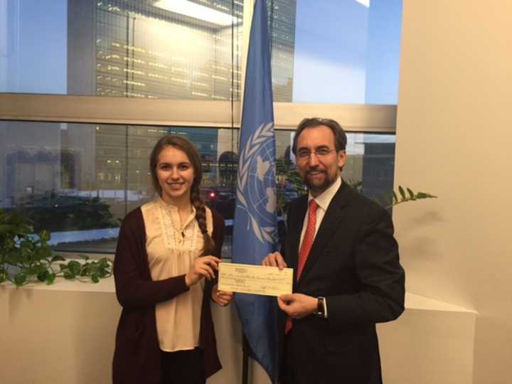 Champion fencer Sylvie Binder presenting a check to the United Nations Human Rights Office.