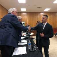 <p>Joseph Barbiera shakes committee members&#x27; hands after being sworn in.</p>