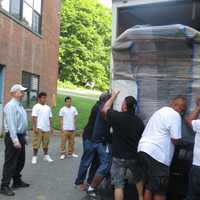 <p>James Coughlin, left, program director at Lincoln Hall, and two teenage carpenters from the boys&#x27; haven in Somers, look on as movers hoist the Papal pulpit into a truck destined for New York City.</p>