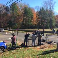 <p>Media wait near the house on Norfield Road where police found what may be human remains</p>