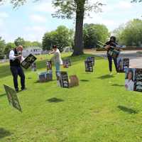 <p>AHHS Principal Joseph Engelhardt, Superintendent Marc Baiocco, parent volunteer Lucie Rambaran and AHHS Assistant Principal Jessica Maracallo, assemble lawn signs to adorn the high school front lawn.</p>