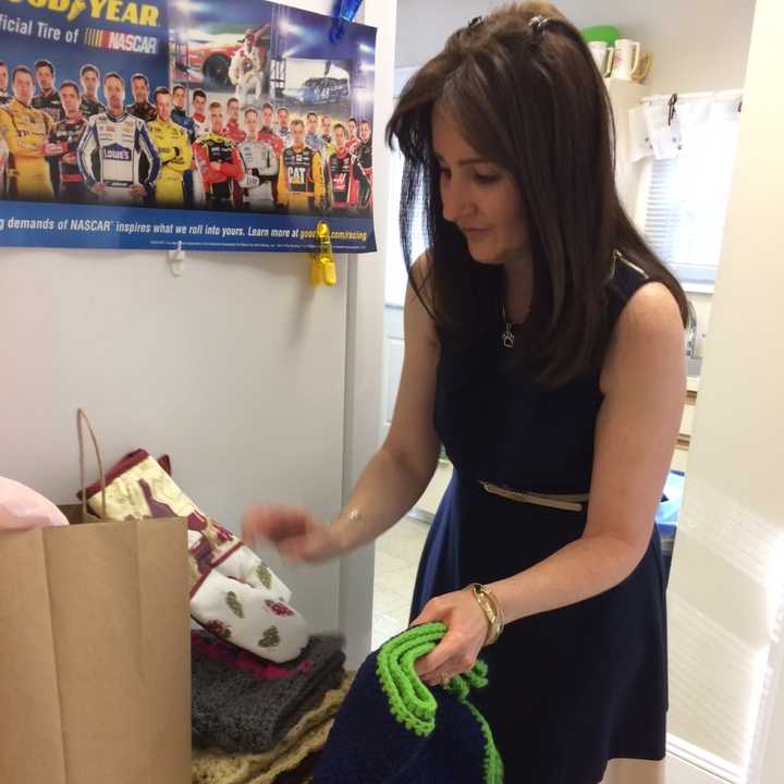 Ann-Marie Lancaster of the Clifton Fire Department sorts through the donated blankets for the Clifton Animal Shelter.