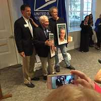 <p>Media take photos of officials celebrating the Paul Newman stamp -- released earlier this year -- at an event Wednesday evening in Westport.</p>