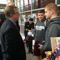 <p>Brookfield Police Chief Robin Montgomery, a decorated Marine veteran, chats with Sam Guttman and Neil Baunach, who have recently enlisted, after the 2015 Trumbull Veterans Day ceremony at Trumbull High School.</p>