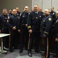 <p>Members of the Little Falls Police Department come together during a swearing-in ceremony for the new chief and lieutenant Monday, Dec. 7.</p>