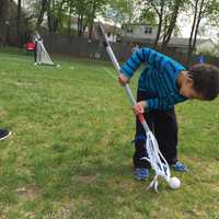 <p>Rodrigo, 6, scoops up the ball.</p>