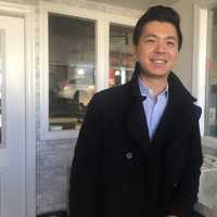 <p>Samuel Sa stands in the renovated waiting room at Meineke in Fair Lawn.</p>