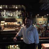 <p>Bartender Will Secchi poses behind the bar. </p>