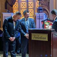 <p>Bergen County Prosecutor’s Chief of Detectives Robert Anzilotti joins Prosecutor Mark Musella in presenting a plaque to Russo.</p>