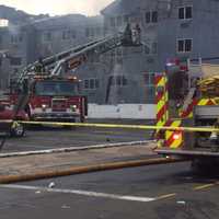 <p>Firefighters fight a smoldering blaze at 215 Charles Street in Bridgeport.</p>