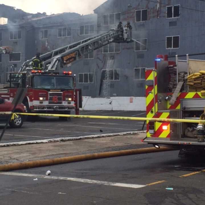 Firefighters fight a smoldering blaze at 215 Charles Street in Bridgeport.