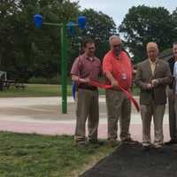 <p>Danbury Mayor Mark Boughton cuts the ribbon at the new spray park at Kenosia Park.</p>