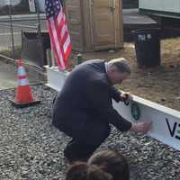 <p>James Maloney of CIFC signs the final beam to be placed in the skeleton of the future Greater Danbury Community Health Center.</p>