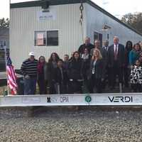 <p>Representatives from the Connecticut Institute for Communities and Verdi Construction celebrate the final beam being hoisted into place at the future site of the Greater Danbury Community Health Center.</p>