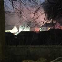 <p>Smoke and fire are visible in the neighborhood from a house fire at 26 Underhill St. on Wednesday afternoon.</p>