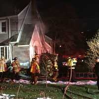 <p>Stamford firefighters tackle the blaze in a home at 26 Underhill St. on Wednesday afternoon.</p>