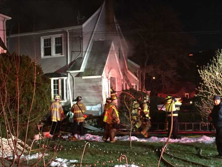 Stamford firefighters tackle the blaze in a home at 26 Underhill St. on Wednesday afternoon.