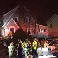 <p>Stamford firefighters tackle the blaze in a home at 26 Underhill St. on Wednesday afternoon.</p>