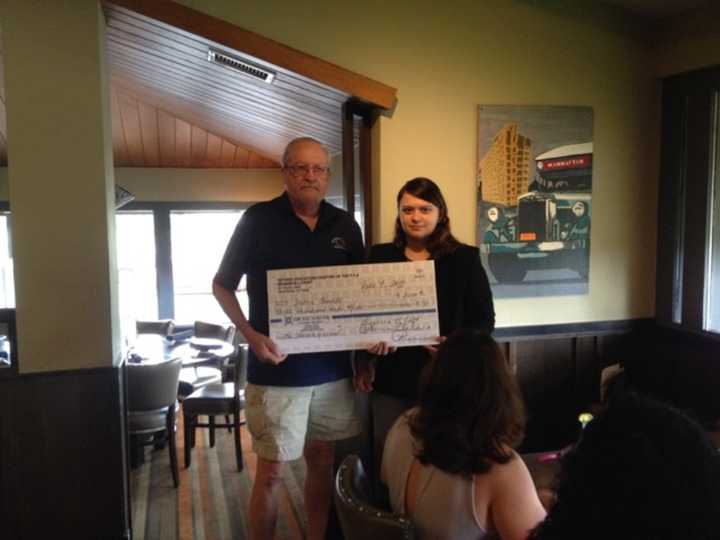 Bob Hudson, presient of the REC-PFA presents a $3000 check to Jamie Acevedo, a senior at Peekskill High School