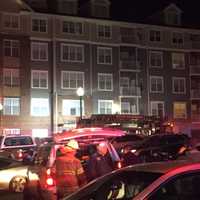 <p>Firefighters outside of the 2000 building in Hackensack where three were transported to the hospital Thursday.</p>