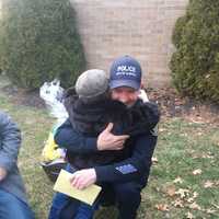 <p>David Samiel II hugs Officer Francisco Sanchez.</p>