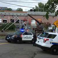 <p>Police on scene of a damaged grade crossing where a car hit a gate in Danbury.</p>