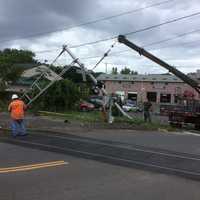 <p>Metro-North crews work to repair a damaged gate after it was hit by a car.</p>