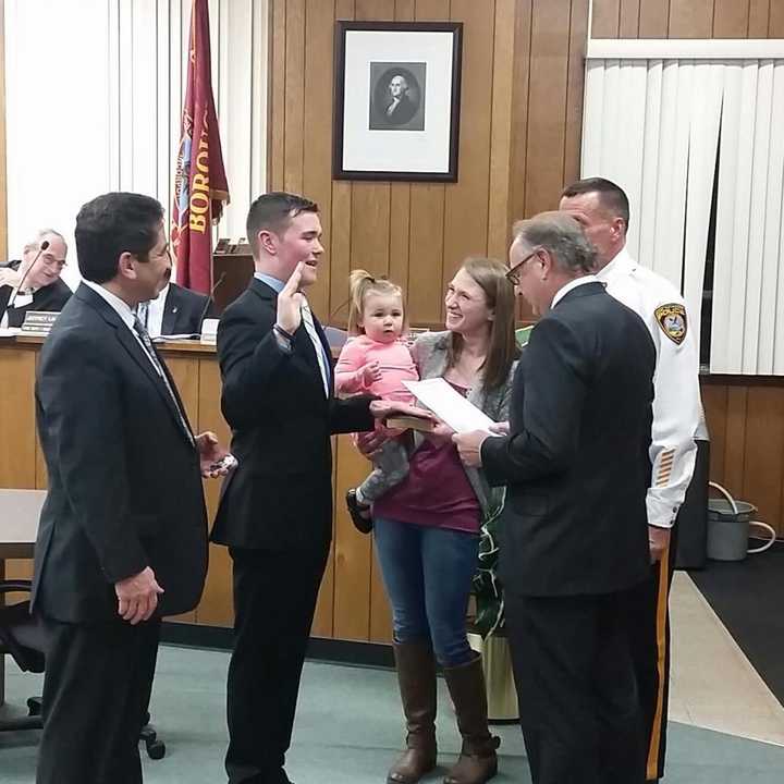 John DeCamp Jr. is sworn in as wife, Rachel, and their daughter, Riley, look on.