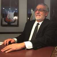 <p>Louis Aloia sits in an office at his Garfield Funeral home.</p>