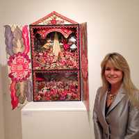 <p>College of New Rochelle President Judith Huntington alongside a Peruvian interpretation of Christ&#x27;s birth. </p>