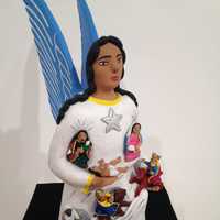 <p>A Mexican ceramic angel holding the Holy Family.</p>