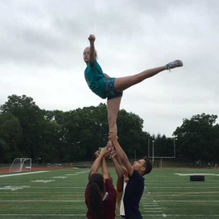 The Norwalk High School cheerleaders are raising money to attend a National Cheerleading Association summer camp.