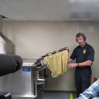 <p>Westchester County Police Det. Arthur Holzman demonstrating one of the department&#x27;s new tools by firing a gun into a water chamber.</p>