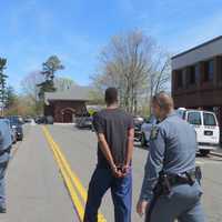 <p>Jean-Pierre Filtcher, 24, of New Rochelle being taken back to Westchester County Jail by state police after his court arraignment Tuesday afternoon at Harrison Town Court.</p>