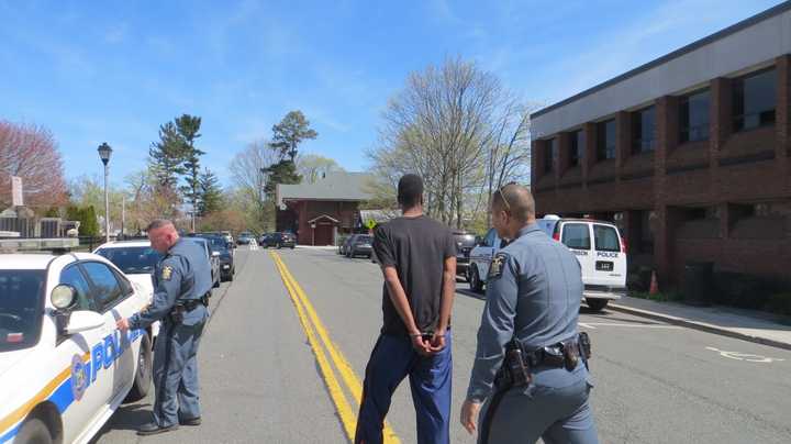 Jean-Pierre Filtcher, 24, of New Rochelle being taken back to Westchester County Jail by state police after his court arraignment Tuesday afternoon at Harrison Town Court.