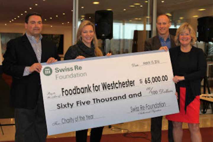 From left, Nicholas Penn, vice president at Swiss Re; Maria Bronzi, board chairperson of Food Bank for Westchester, Neil Sprackling, managing director at Swiss Re; and Ellen Lynch, CEO of the food bank.