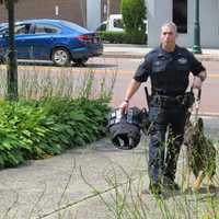 <p>New Rochelle K-9 Officer Marc Weinerman with his partner Tank and his new vest.</p>