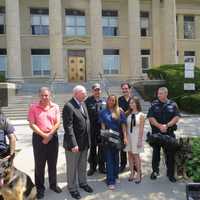 <p>New Rochelle residents Jessica Levine and Jennifer Ubl presenting the police department with new bulletproof vests for the K9 unit.</p>