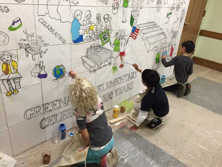 Kids painting mural at Greenacres Elementary School