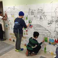 <p>Kids painting Betsy Franco Feeney&#x27;s mural</p>