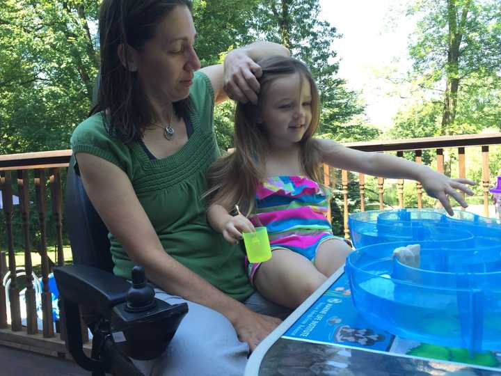 Donna Myhre of Oakland plays with daughter Mikayla.