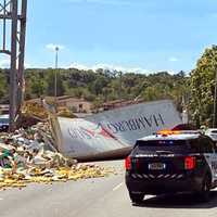 <p>The trailer landed on the other side of the highway onto the front of a passing SUV.</p>