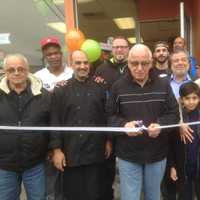 <p>Lyndhurst Mayor Robert Giangeruso cuts the ribbon at "Hummus &amp; Guac."</p>