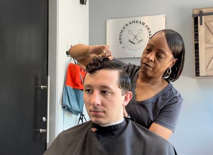 Monica Dooley works on a client at her shop, Monica&#x27;s Shear Images, in Arlington.