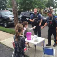 <p>Fair Lawn police officers Tim Ammann, left, and Luis Vazquez say their day was made by Yocheved and Ahuva&#x27;s lemonade stand.</p>