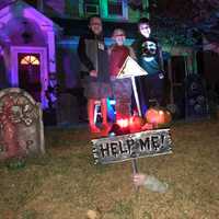 <p>Brody, far right, with his Clinton Avenue neighbors Connor, far left, and Luca, center. The trio -- and more neighbors -- decorated all of the pumpkins on the lawn.</p>