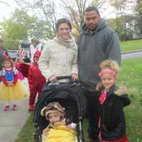 <p>A monkey and Princess Elena pose with their parents at the Briarcliff Ragamuffin Parade.</p>